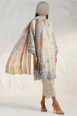 A stunning, traditional Pakistani or Indian lawn suit with intricate embroidery on the front and sleeves. The suit includes a flowing chiffon dupatta and comfortable cotton trousers.